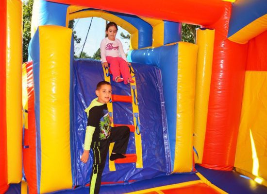 kids playing in royal bounce house